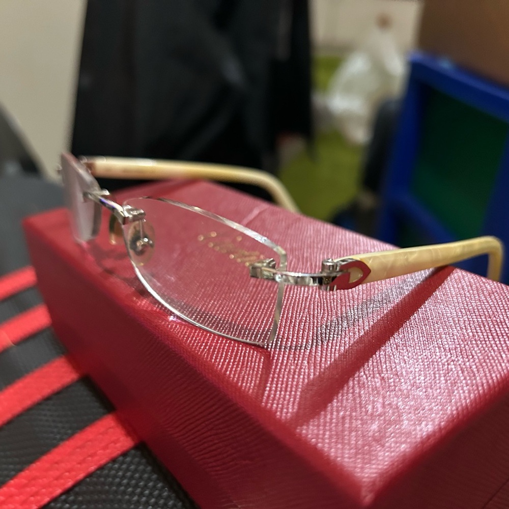 Cartier Cream Glasses with Frameless Design and Clear Lenses